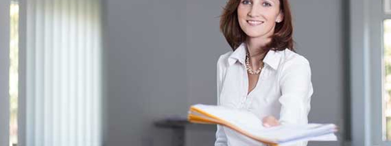 Woman handing a folder out